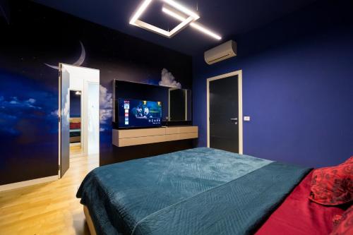 a bedroom with a bed and a flat screen tv at Tirana Center Luxury Landing in Tirana
