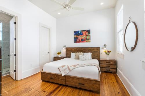 a bedroom with a bed and a mirror at 3BR Cottage on Carondelet by Hosteeva in New Orleans