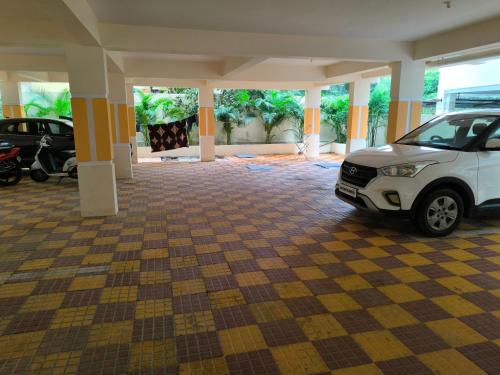 a garage with a white car parked in it at Orraica Stays Vajra Rao Luxe in Gundipet