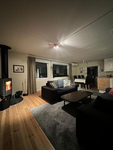 a living room with a couch and a table at Camp Caroli Family House in Jukkasjärvi