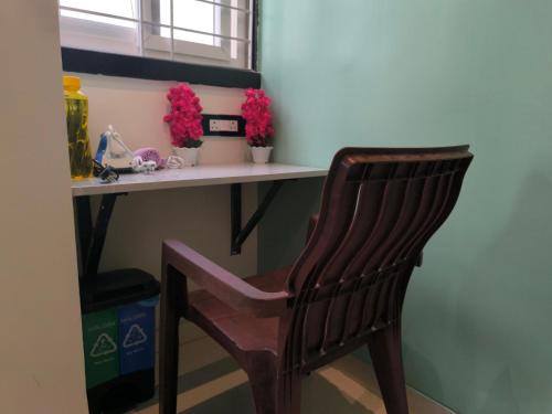 a wooden chair sitting in front of a desk at Orraica Stays Vajra Rao Luxe in Gundipet