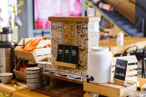 a counter with bread and other food items at Hotel Schani Wien Hauptbahnhof in Vienna