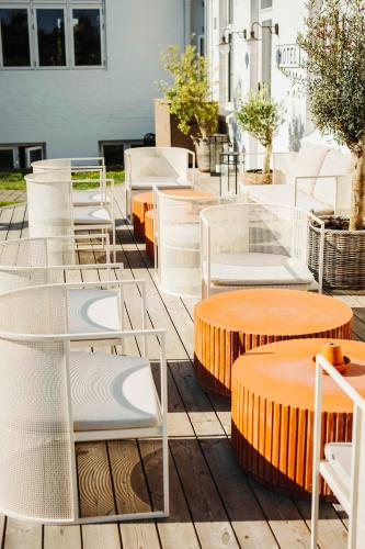 a group of chairs and tables on a patio at The Falcon Hotel in Allinge