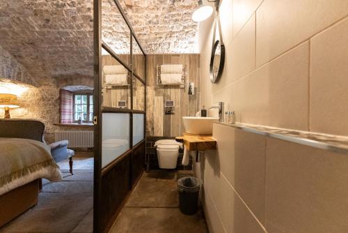 a bathroom with a sink and a toilet at Gileston Manor-Self catering in Saint Athans