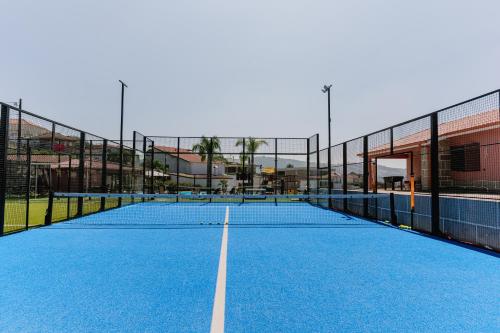 a tennis court with two tennis rackets on it at Belo Encanto in Felgueiras