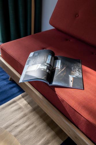 a book with a picture of a car on a bed at MiraOdle Apartments in Villnoss