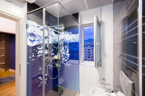 a bathroom with a shower with a snowflake mural at Tirana Center Luxury Landing in Tirana
