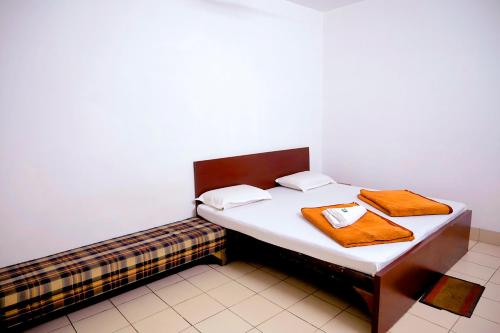 a bed in a room with two towels on it at Subhash Hotel in Prayagraj