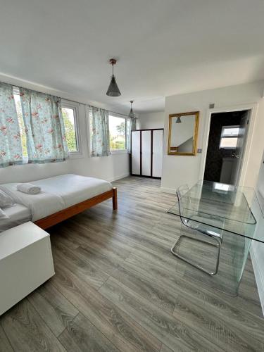 a bedroom with a bed and a glass table at Fairestone House in Glenfield