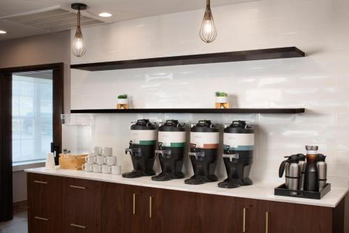 a row of rubber boots on a counter in a kitchen at Residence Inn by Marriott Fort Smith in Massard