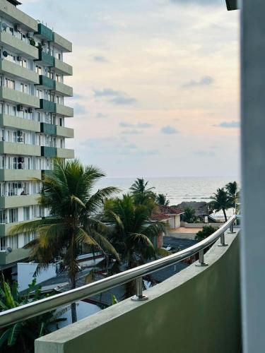a view of the ocean from the balcony of a building at Green Tree Apartments in Dehiwala
