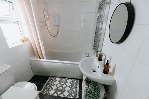 a bathroom with a sink and a tub and a toilet at SUN COTTAGE - Cosy Cottage in Ulverston with a log burner in Ulverston, Cumbria in Ulverston