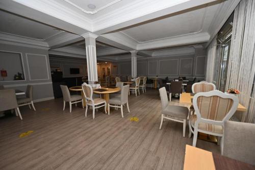 a dining room with tables and chairs in a room at NkALBATROS HOTEL in Istanbul