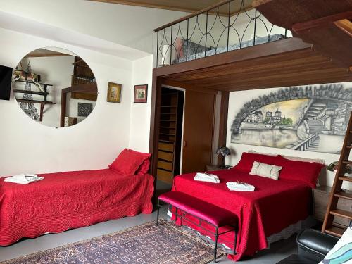 a bedroom with two beds and a mirror at Flor de Limão Hotel Boutique in Coroa Vermelha