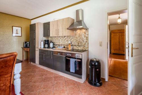 a kitchen with a sink and a stove top oven at Seehotel Lichtenberg in Lichtenberg