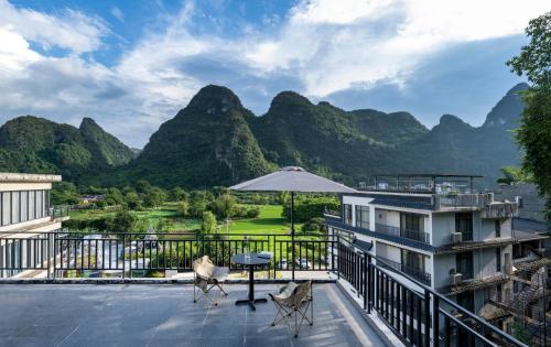 a view from the balcony of a resort with mountains at Yangshuo-Greenery Retreat in Yangshuo