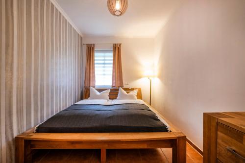 a bedroom with a large bed with a window at Seehotel Lichtenberg in Lichtenberg