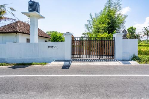 a fence with a gate in front of a house at Aura Apartments Ubud in Ubud