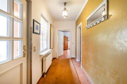 an empty hallway with a door and windows at Seehotel Lichtenberg in Lichtenberg