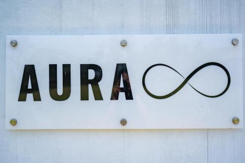 a sign for aza on a white wall at Aura Apartments Ubud in Ubud