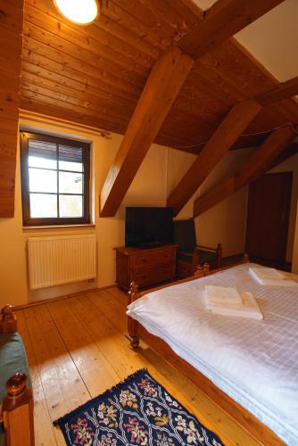 a bedroom with a large bed and a window at Hotel Na Vyhlídce in Kořenov