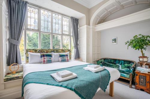 a bedroom with a large bed with towels on it at 7 Arndale Court in York