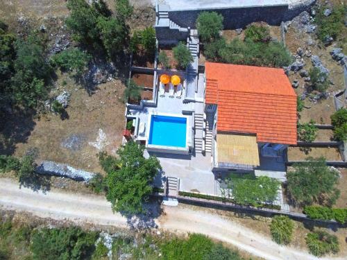 an overhead view of a house with a swimming pool at House Tonko in Postira