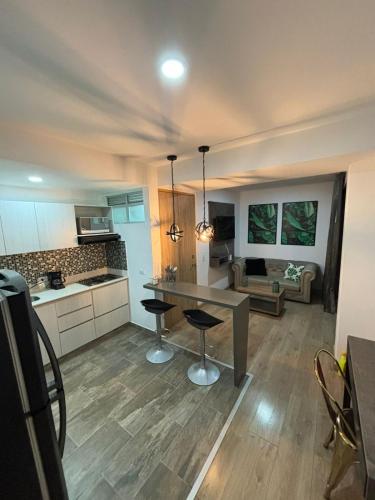 a kitchen and living room with a table and chairs at Unidad recidencial San basilio in Sabaneta