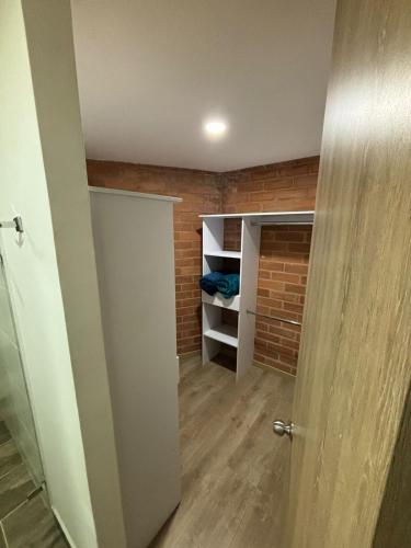 a room with a closet with a brick wall at Unidad recidencial San basilio in Sabaneta