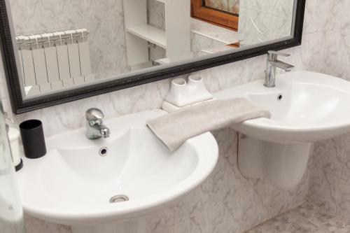 a bathroom with a sink and a toilet and a mirror at Red Clay Apartments City Club in Belgrade