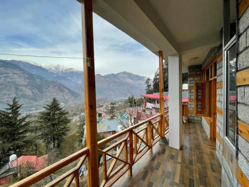 a balcony with a view of the mountains at Kutumb Homestay Naggar in Nagar
