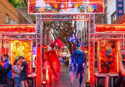 a group of people standing around a street market at City at Your Doorstep in Sydney