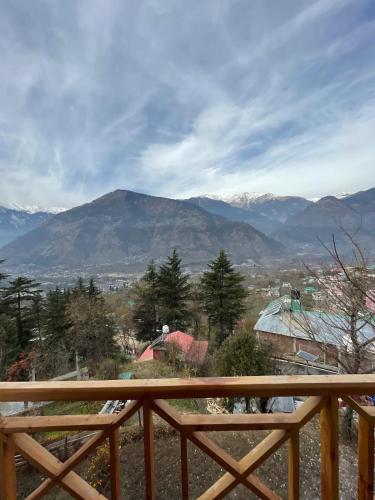 a view of a mountain from the balcony of a house at Kutumb Homestay Naggar in Nagar