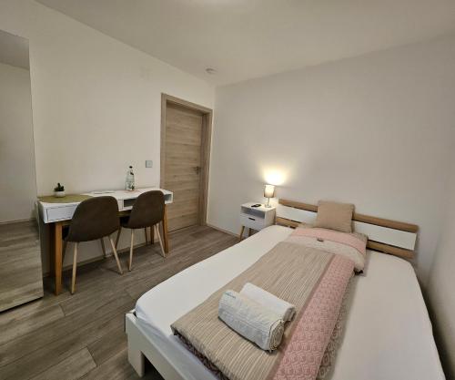 a bedroom with a bed and a desk and a table at Schatteneck in Dinkelsbühl