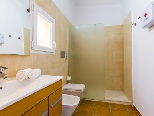 a bathroom with a toilet and a sink and a shower at Casa Marineta III in Denia