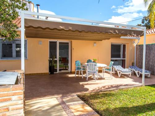 a patio with a table and chairs in a yard at Casa Marineta III in Denia