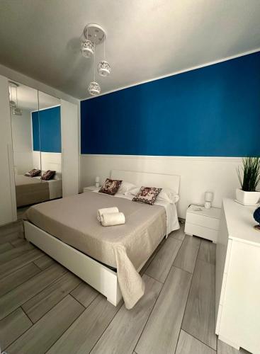 a bedroom with a large bed with a blue wall at La Pace in Savoca 