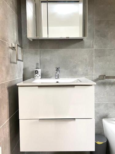 a bathroom with a white sink and a mirror at A-B House in Padova