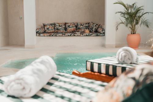 a living room with a pool and a couch at Eden Escapes - Diani Beach, Kenya in Diani Beach