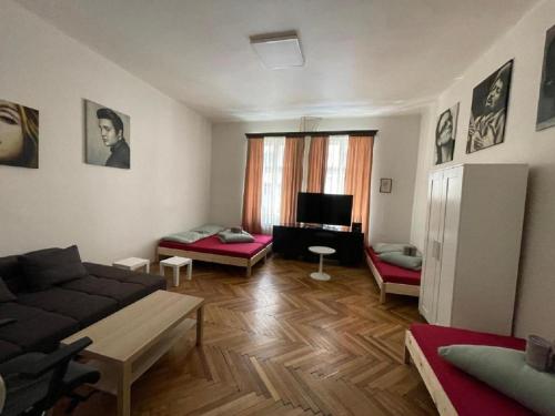 a living room with a couch and a table at Red&Black Apartment City centr, Na Hradbách 118 in Ostrava