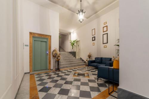 a living room with a staircase and a blue couch at JOIVY Cavour 238 in Rome