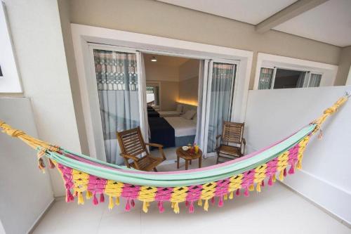 a hammock in a room with a bedroom at The Falls Hotel in Guarujá