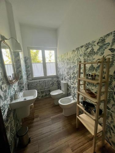 a bathroom with two sinks and two toilets at Sicily in Love - Rooms and Apartment - Pedara Catania Etna in Pedara