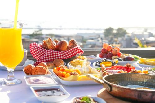 a table topped with plates of food and a glass of orange juice at HOTEL BRONTE in Istanbul