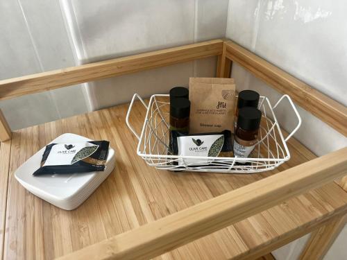 a shelf with a basket of products on a table at Sicily in Love - Rooms and Apartment - Pedara Catania Etna in Pedara