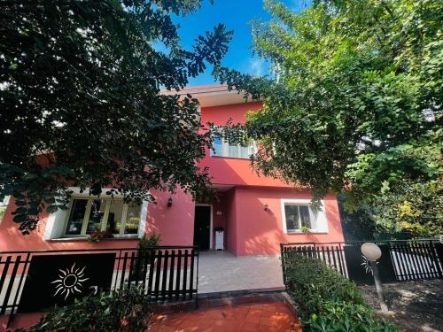 a pink house with a fence in front of it at Sicily in Love - Rooms and Apartment - Pedara Catania Etna in Pedara