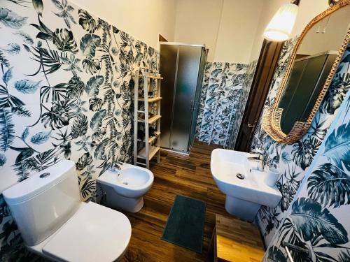 a bathroom with a toilet and a sink at Sicily in Love - Rooms and Apartment - Pedara Catania Etna in Pedara