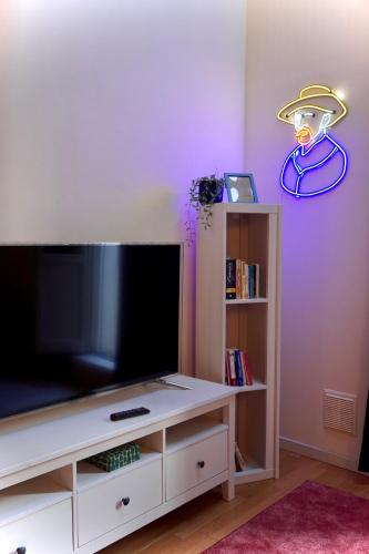 a entertainment center with a flat screen tv in a room at Cozy flat in Fontanellato