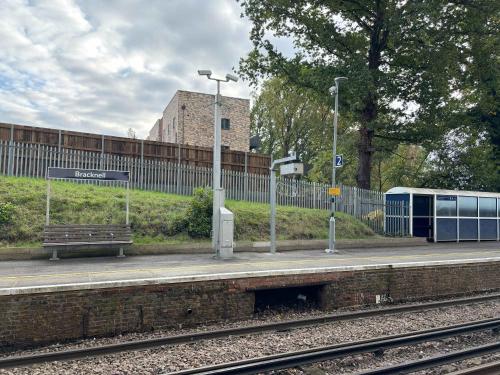 a train station with a bench and street lights at Grand Exchange near Ascot 2 bed with Parking in Bracknell