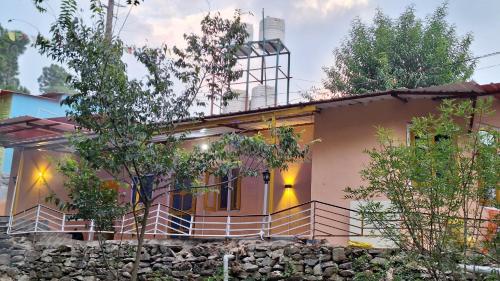 a house with a stone wall at TATHASTU Bir -Homestay ,DORM,HOSTEL in Bīr